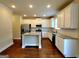 Modern kitchen with white cabinets, stainless steel appliances, and granite countertops at 542 Hinton Farm Way, Dacula, GA 30019