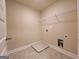 An interior view of a laundry room features white walls, tile floors, and white wire shelving at 542 Hinton Farm Way, Dacula, GA 30019