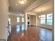 Open living space featuring hardwood floors, a fireplace, and ample natural light from large windows and glass doors at 542 Hinton Farm Way, Dacula, GA 30019