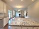 Open floor plan view from the kitchen featuring a fireplace and hardwood floors at 542 Hinton Farm Way, Dacula, GA 30019