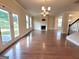 Bright living room with a fireplace, hardwood floors, and french doors leading to the outdoors at 542 Hinton Farm Way, Dacula, GA 30019