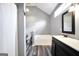 Modern bathroom featuring a soaking tub and vanity with a black frame mirror at 146 Calico Loop, Grantville, GA 30220