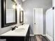 Bathroom with double sink vanity, framed mirrors, and tub/shower combo at 146 Calico Loop, Grantville, GA 30220