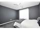 Bedroom with gray walls, a white ceiling fan, and a window with sheer curtains at 146 Calico Loop, Grantville, GA 30220