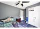 A bedroom features a ceiling fan, double door closet, and blue carpet at 146 Calico Loop, Grantville, GA 30220