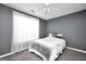 Bedroom with gray walls, a white ceiling fan, and a window with sheer curtains at 146 Calico Loop, Grantville, GA 30220