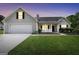Charming one story home with a well manicured lawn and covered front porch at dusk at 146 Calico Loop, Grantville, GA 30220