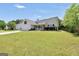 Well maintained one story home with a long front lawn and well manicured bushes at 146 Calico Loop, Grantville, GA 30220