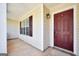 Covered front porch with a red door, offering a welcoming entrance to the home at 146 Calico Loop, Grantville, GA 30220
