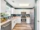 Well-lit kitchen with white cabinets, stainless steel appliances, and an aquarium on the counter at 146 Calico Loop, Grantville, GA 30220
