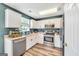 Well-lit kitchen with white cabinets, stainless steel appliances, and a window over the sink at 146 Calico Loop, Grantville, GA 30220