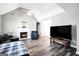 Inviting living room with hardwood floors, fireplace, vaulted ceiling, and comfortable furnishings at 146 Calico Loop, Grantville, GA 30220