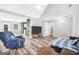 Spacious living room with open floor plan, hardwood floors, and a view into the kitchen at 146 Calico Loop, Grantville, GA 30220