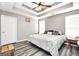 Spacious main bedroom features a tray ceiling, ceiling fan, and wood-look flooring at 146 Calico Loop, Grantville, GA 30220