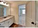 Bathroom with a modern vanity and adjacent bedroom view at 147 Tara Blvd, Loganville, GA 30052