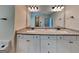 Bright bathroom featuring double vanity with granite countertop and white cabinets at 147 Tara Blvd, Loganville, GA 30052