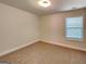 This is a neutral bedroom with tan carpet and light colored walls and trim and a window at 147 Tara Blvd, Loganville, GA 30052