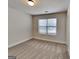 This is a neutral bedroom with tan carpet and light colored walls and trim and a window at 147 Tara Blvd, Loganville, GA 30052