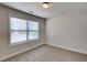 This bedroom features carpeting and a window with blinds for natural light at 147 Tara Blvd, Loganville, GA 30052