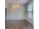Elegant dining room featuring hardwood floors, wainscoting, and a chandelier at 147 Tara Blvd, Loganville, GA 30052