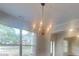 Dining room with a statement chandelier, light walls, and large window for natural light at 147 Tara Blvd, Loganville, GA 30052