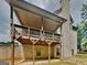 View of home exterior featuring a large elevated deck and brick facade at 147 Tara Blvd, Loganville, GA 30052