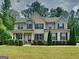 Charming two-story home with a covered front porch and well-manicured lawn at 147 Tara Blvd, Loganville, GA 30052