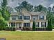Charming two-story home features a landscaped yard and a welcoming front porch at 147 Tara Blvd, Loganville, GA 30052