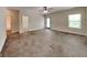 Large living room featuring concrete floors, a fan, and direct access to the backyard at 147 Tara Blvd, Loganville, GA 30052