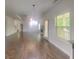 Open-concept living room with hardwood floors, fireplace, and plenty of natural light at 147 Tara Blvd, Loganville, GA 30052