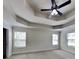 Inviting primary bedroom featuring a tray ceiling and a ceiling fan for added comfort at 147 Tara Blvd, Loganville, GA 30052