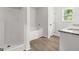 Modern bathroom showcasing a sleek walk-in shower, tub, and vanity with granite countertops and a window at 3209 Broadnax Mill Rd # 6, Loganville, GA 30052