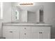 Bathroom with double sink vanity, granite counters, white cabinetry, a window and a large mirror at 3209 Broadnax Mill Rd # 6, Loganville, GA 30052