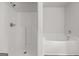 All-white bathroom with walk-in shower and separate soaking tub, featuring clean lines and modern fixtures at 3209 Broadnax Mill Rd # 6, Loganville, GA 30052