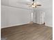 This bedroom features wood-look floors, white trim, and white doors that lead to other rooms in the house at 3209 Broadnax Mill Rd # 6, Loganville, GA 30052