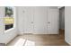 Bedroom featuring neutral paint, wood floors, and two white doors at 3209 Broadnax Mill Rd # 6, Loganville, GA 30052