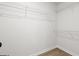 Empty walk-in closet with wood-look flooring and wire shelving, ready for personalized organization at 3209 Broadnax Mill Rd # 6, Loganville, GA 30052