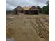 Framed exterior of a new home showcasing its structure and design on a large lot in a rural area at 3209 Broadnax Mill Rd # 6, Loganville, GA 30052