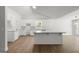 Open kitchen featuring white cabinetry, granite countertops, and a center island at 3209 Broadnax Mill Rd # 6, Loganville, GA 30052