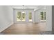 Bright living space with hardwood floors, and large windows, creating a cozy and inviting atmosphere at 3209 Broadnax Mill Rd # 6, Loganville, GA 30052