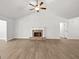 Open living room with a brick fireplace, ceiling fan, and durable floors at 3209 Broadnax Mill Rd # 6, Loganville, GA 30052