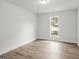 Well-lit bedroom featuring wood floors and a window with views to the outdoors at 3219 Broadnax Mill Rd # 5, Loganville, GA 30052