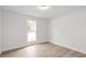 Bright bedroom featuring hardwood floors and a window with an outside view at 3219 Broadnax Mill Rd # 5, Loganville, GA 30052