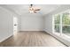 Bright, airy bedroom featuring modern ceiling fan and a large window with scenic view at 3219 Broadnax Mill Rd # 5, Loganville, GA 30052
