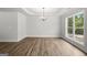 Bright dining room with a tray ceiling and a large window at 3219 Broadnax Mill Rd # 5, Loganville, GA 30052