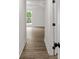 Bright hallway featuring durable wood flooring and neutral paint, leading to a sunlit room at 3219 Broadnax Mill Rd # 5, Loganville, GA 30052