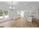 Open-concept living room and kitchen with white cabinets and a center island at 3219 Broadnax Mill Rd # 5, Loganville, GA 30052