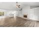 Open-concept living room with a fireplace, built-in shelving, and new flooring at 3219 Broadnax Mill Rd # 5, Loganville, GA 30052