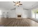 Bright living room with a fireplace, wood flooring, and view to kitchen at 3219 Broadnax Mill Rd # 5, Loganville, GA 30052