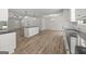 Open concept living room and kitchen area with hardwood floors and white cabinets at 3219 Broadnax Mill Rd # 5, Loganville, GA 30052